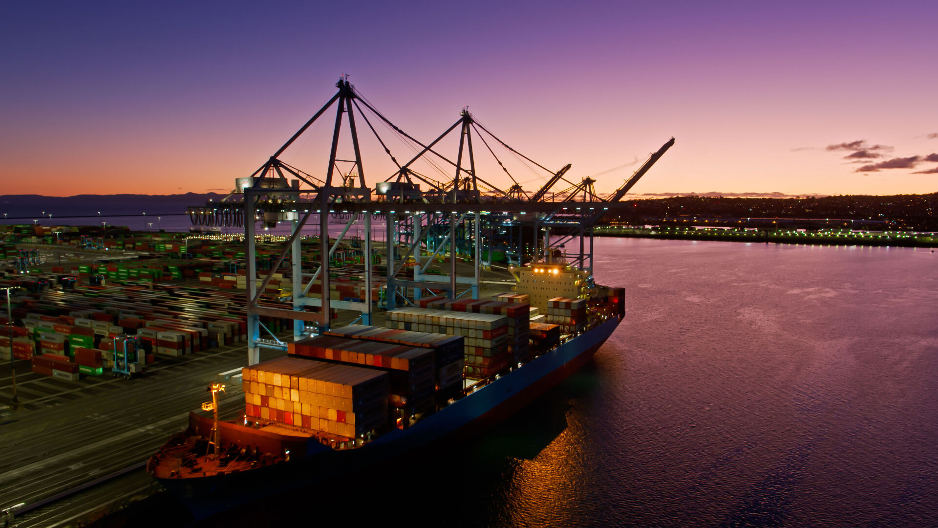 Aerial shot of a massive ship in the Port of Los Angeles at twilight
